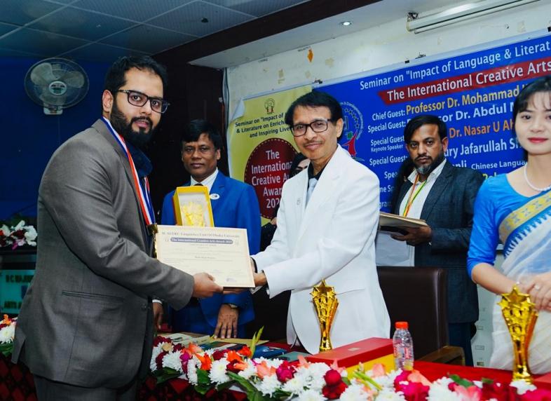 Nadim Shah receiving the award on behalf of his father, Dr. Saber Shah